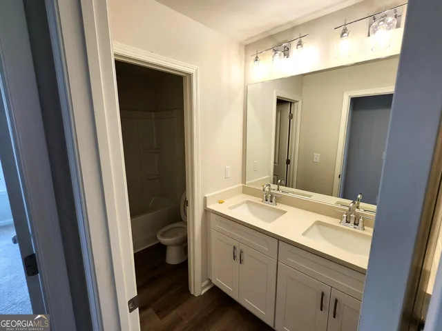 a bathroom with a double vanity sink and a mirror