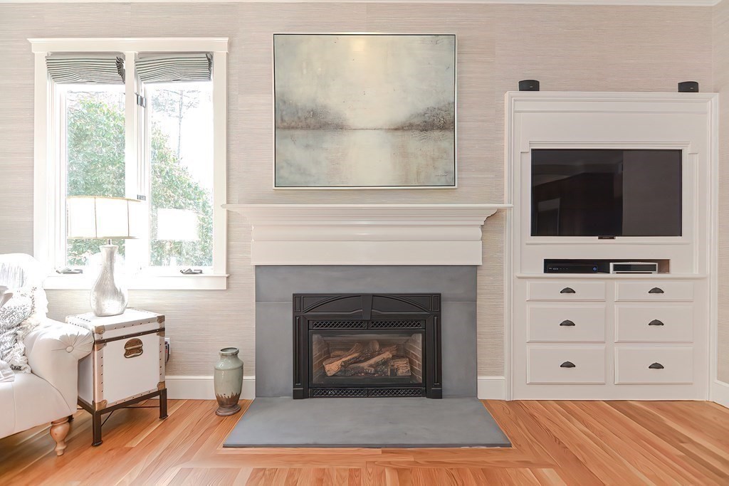 17 Elizabeth Road Hopkinton, MA 01748 - Photo 15 of 40 a living room with furniture a fireplace and a flat screen tv