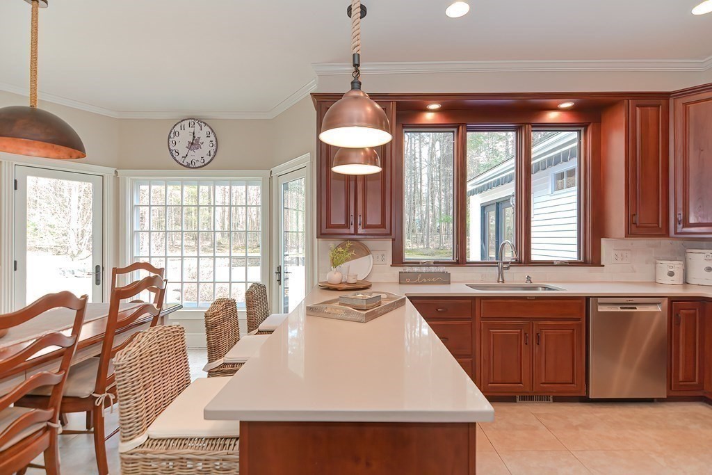 17 Elizabeth Road Hopkinton, MA 01748 - Photo 17 of 40 a kitchen with stainless steel appliances granite countertop a stove a sink dishwasher and a dining table with granite countertops