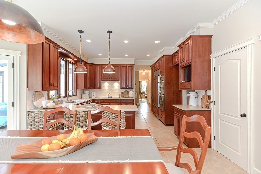 17 Elizabeth Road Hopkinton, MA 01748 - Photo 18 of 40 a view of a kitchen with kitchen island dining table and chairs