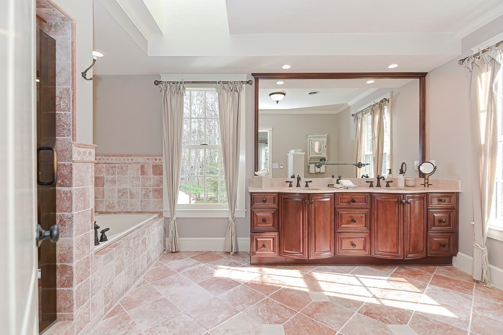 17 Elizabeth Road Hopkinton, MA 01748 - Photo 28 of 40 a spacious bathroom with a tub a double vanity sink and a mirror