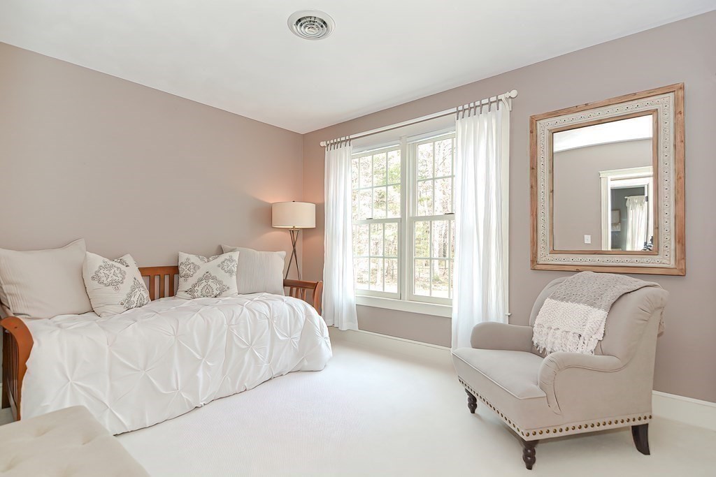17 Elizabeth Road Hopkinton, MA 01748 - Photo 30 of 40 a spacious bedroom with a bed and a couch with exposed radiator