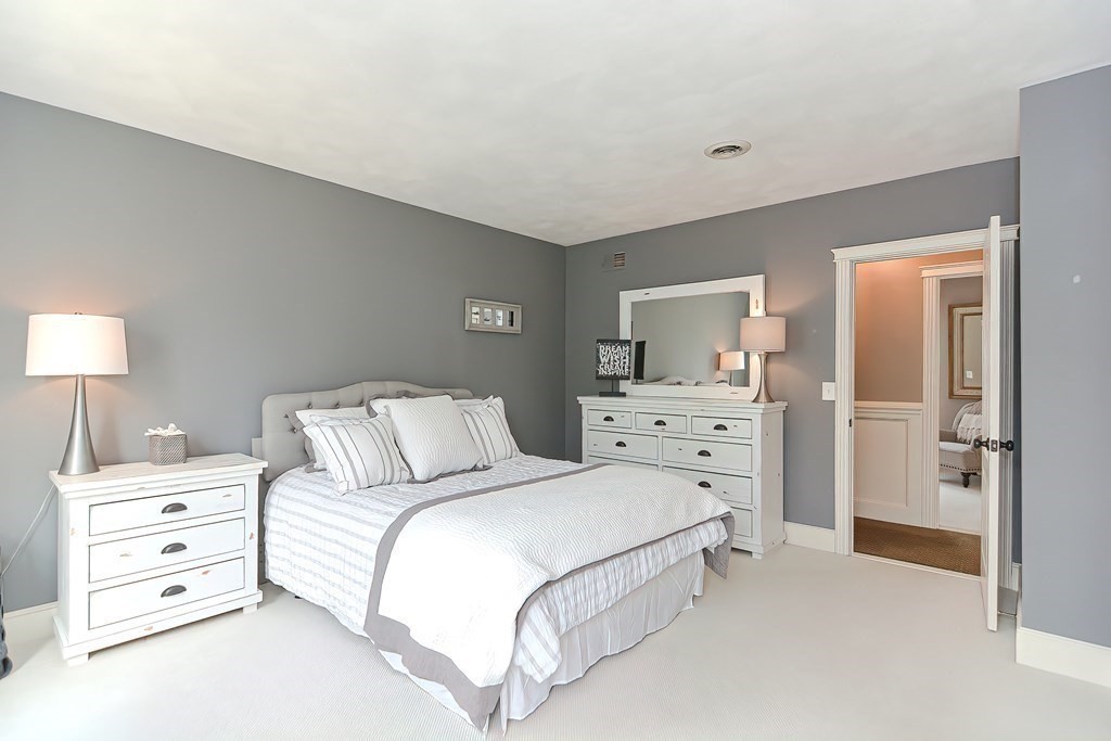 17 Elizabeth Road Hopkinton, MA 01748 - Photo 31 of 40 a spacious bedroom with a bed and a lamp