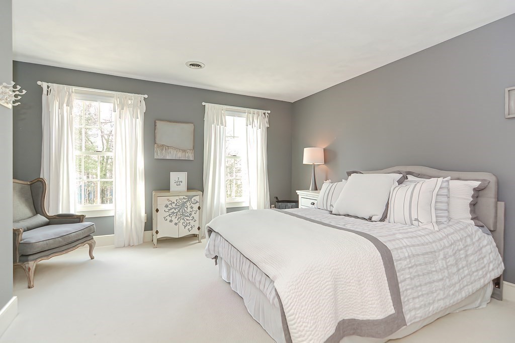 17 Elizabeth Road Hopkinton, MA 01748 - Photo 32 of 40 a spacious bedroom with a bed and a couch
