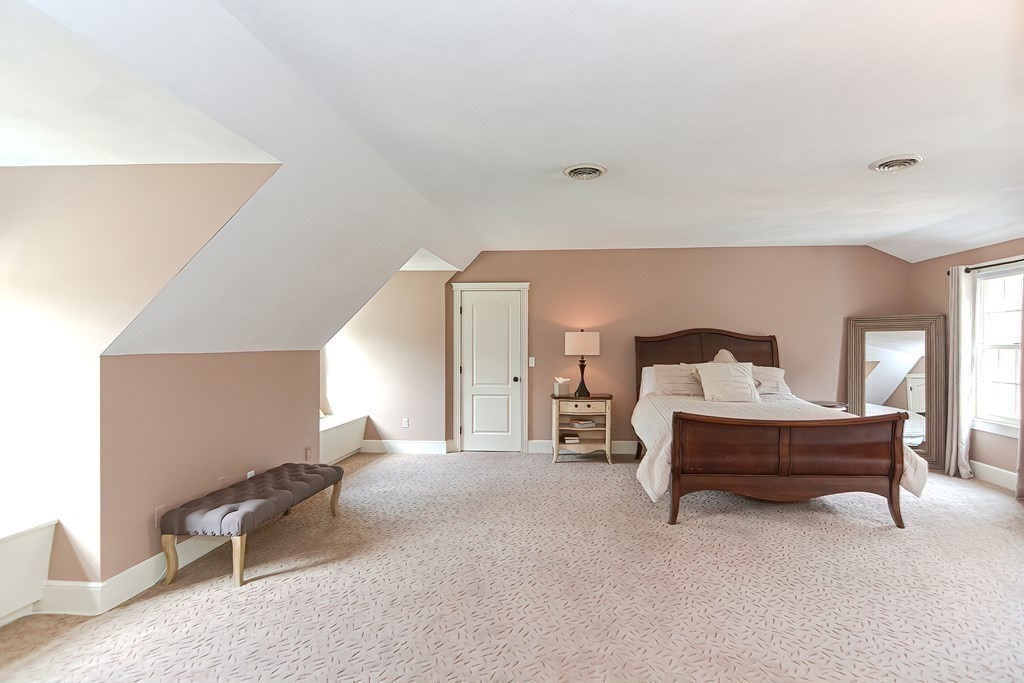 17 Elizabeth Road Hopkinton, MA 01748 - Photo 34 of 40 a spacious bedroom with a bed and chair