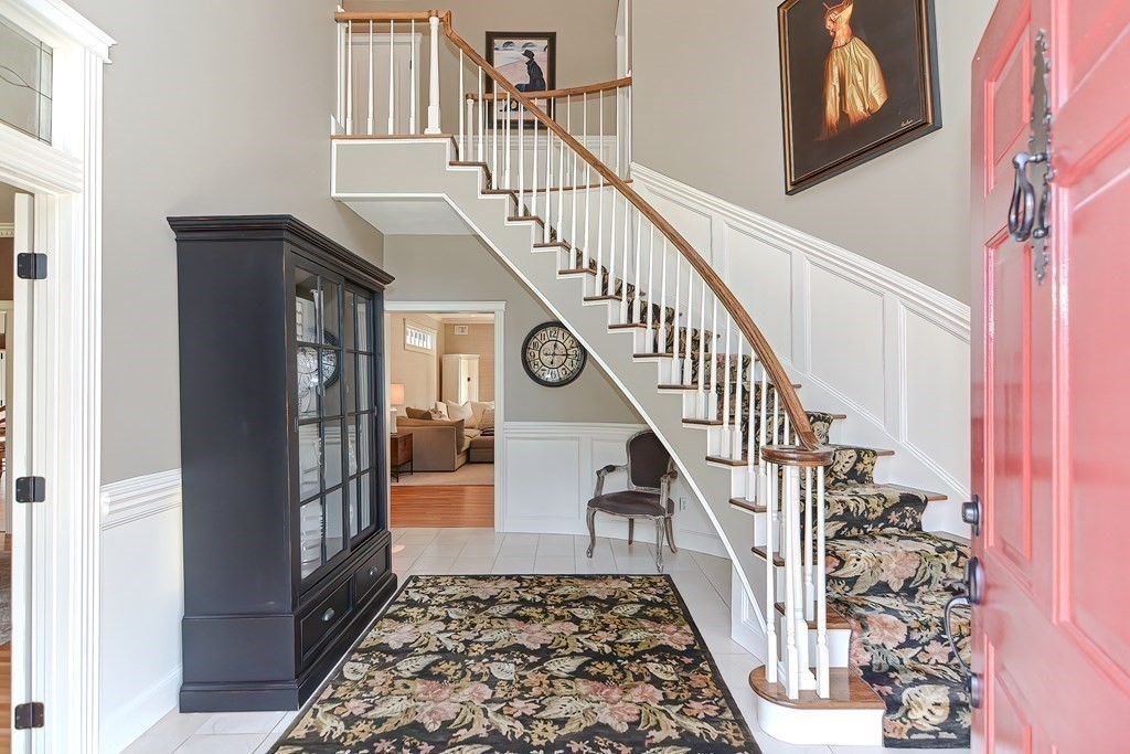 17 Elizabeth Road Hopkinton, MA 01748 - Photo 4 of 40 a view of staircase with lots of frames on wall and a window