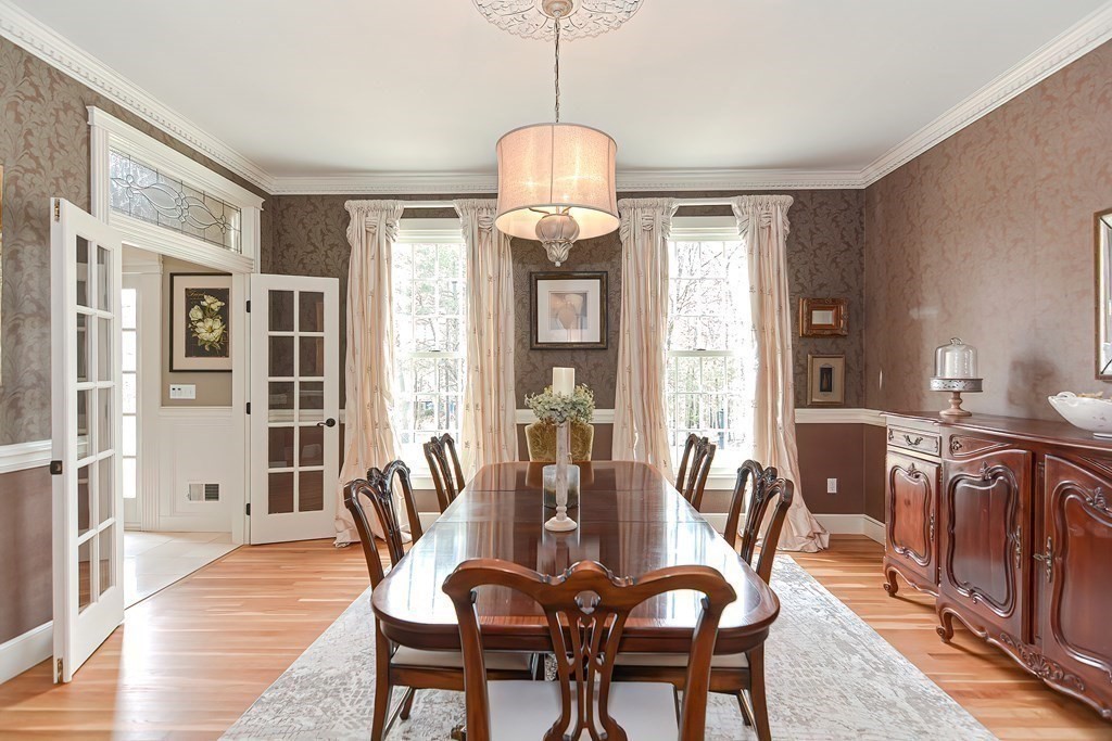 17 Elizabeth Road Hopkinton, MA 01748 - Photo 10 of 40 a dining room with furniture a chandelier and wooden floor