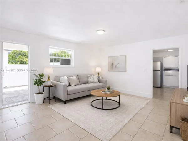 a living room with furniture a window and a table