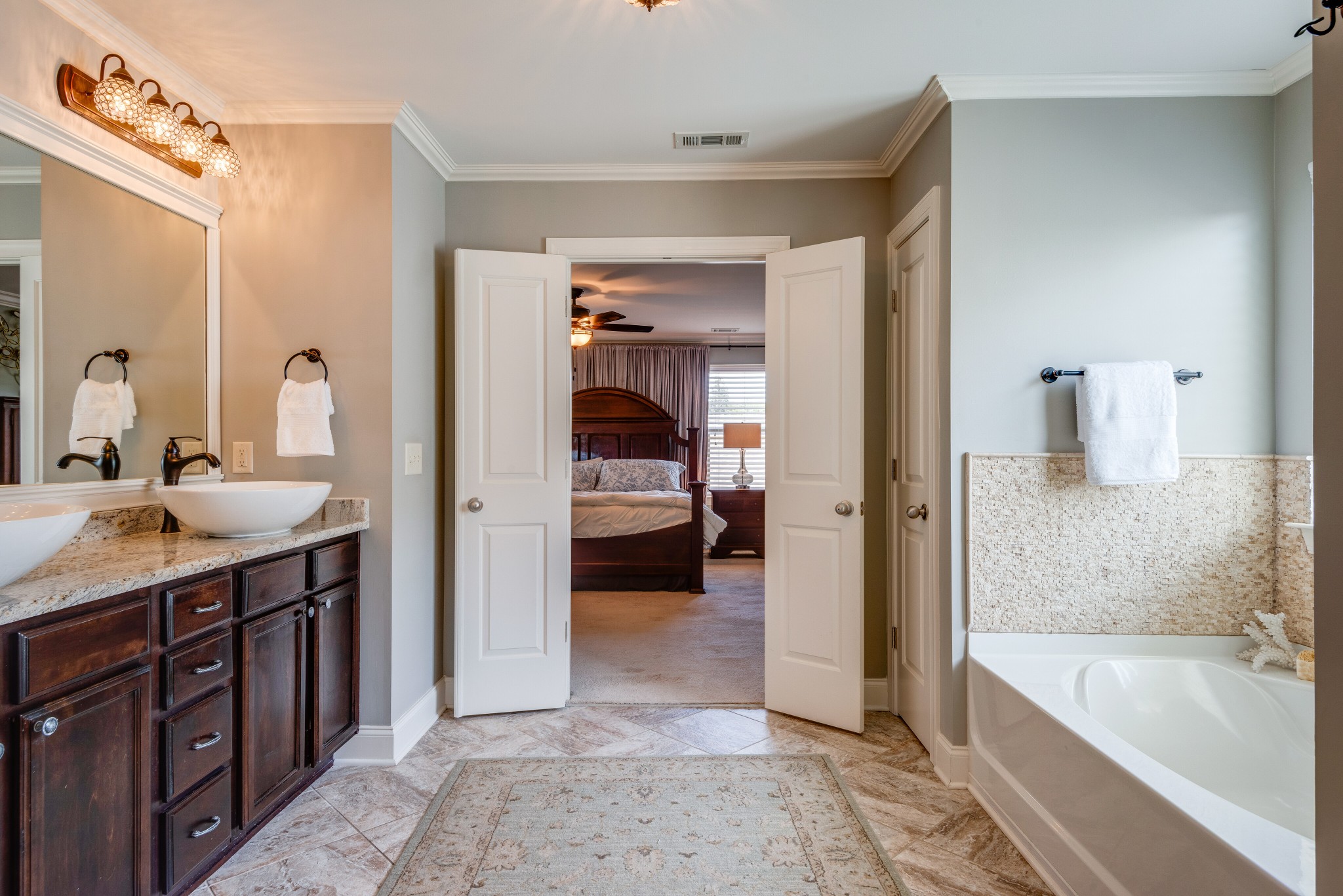 624 Streamside Lane Franklin, TN 37064 - Photo 16 of 33 a en suite bathroom with a tub sink and mirror