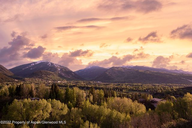 a view of a town with mountains in the background