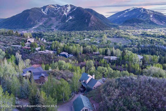 a view of a lush green hillside and a building