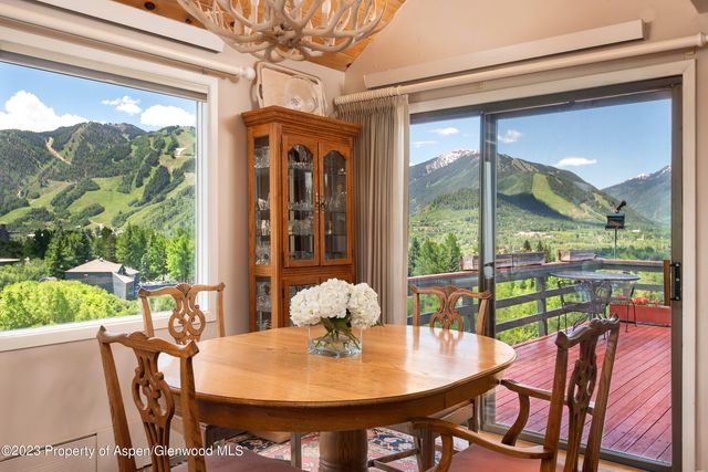 a dining room with a glass table and chairs