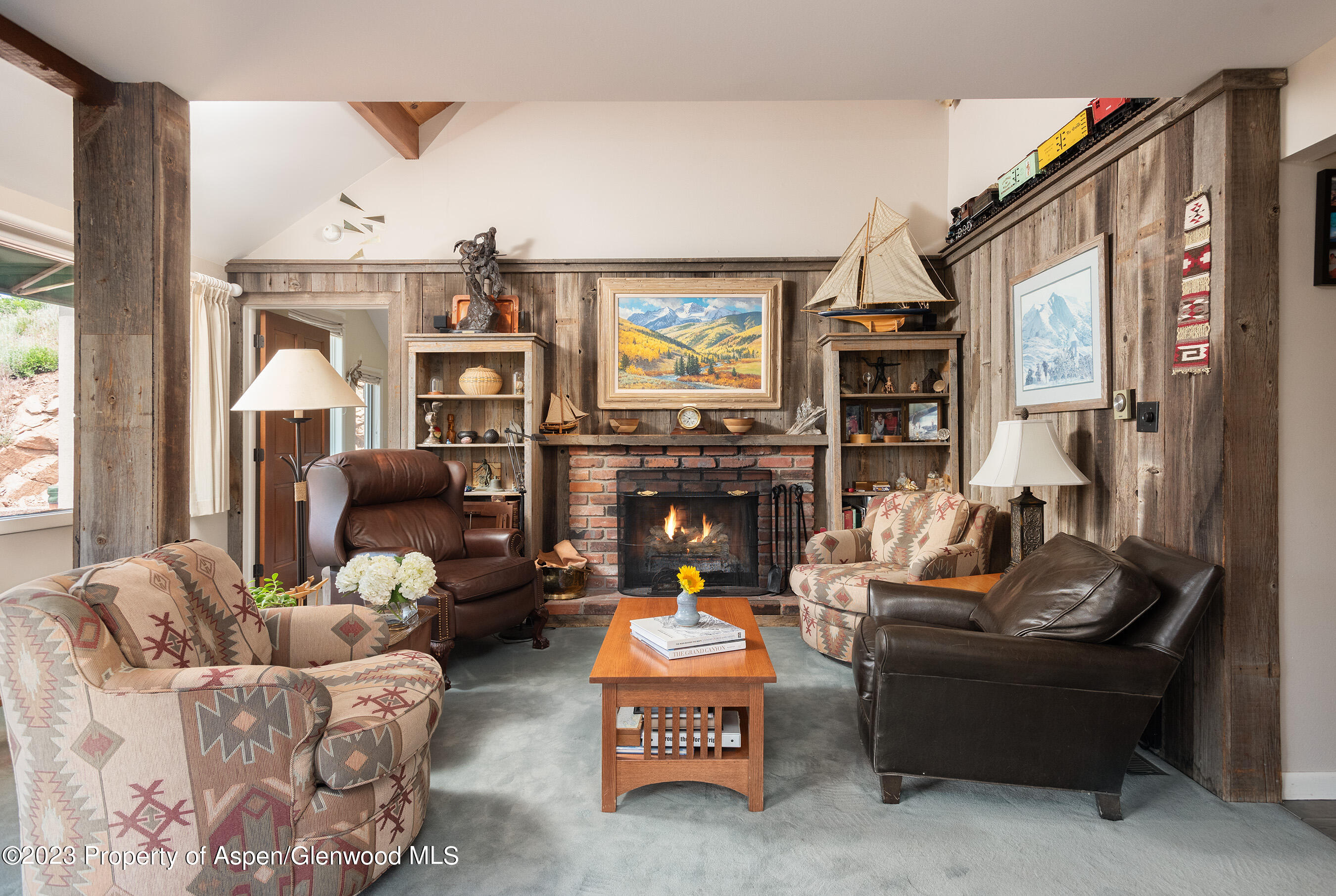 376 Draw Drive Aspen, CO 81612 - Photo 5 of 34 a living room with fireplace furniture and a large window