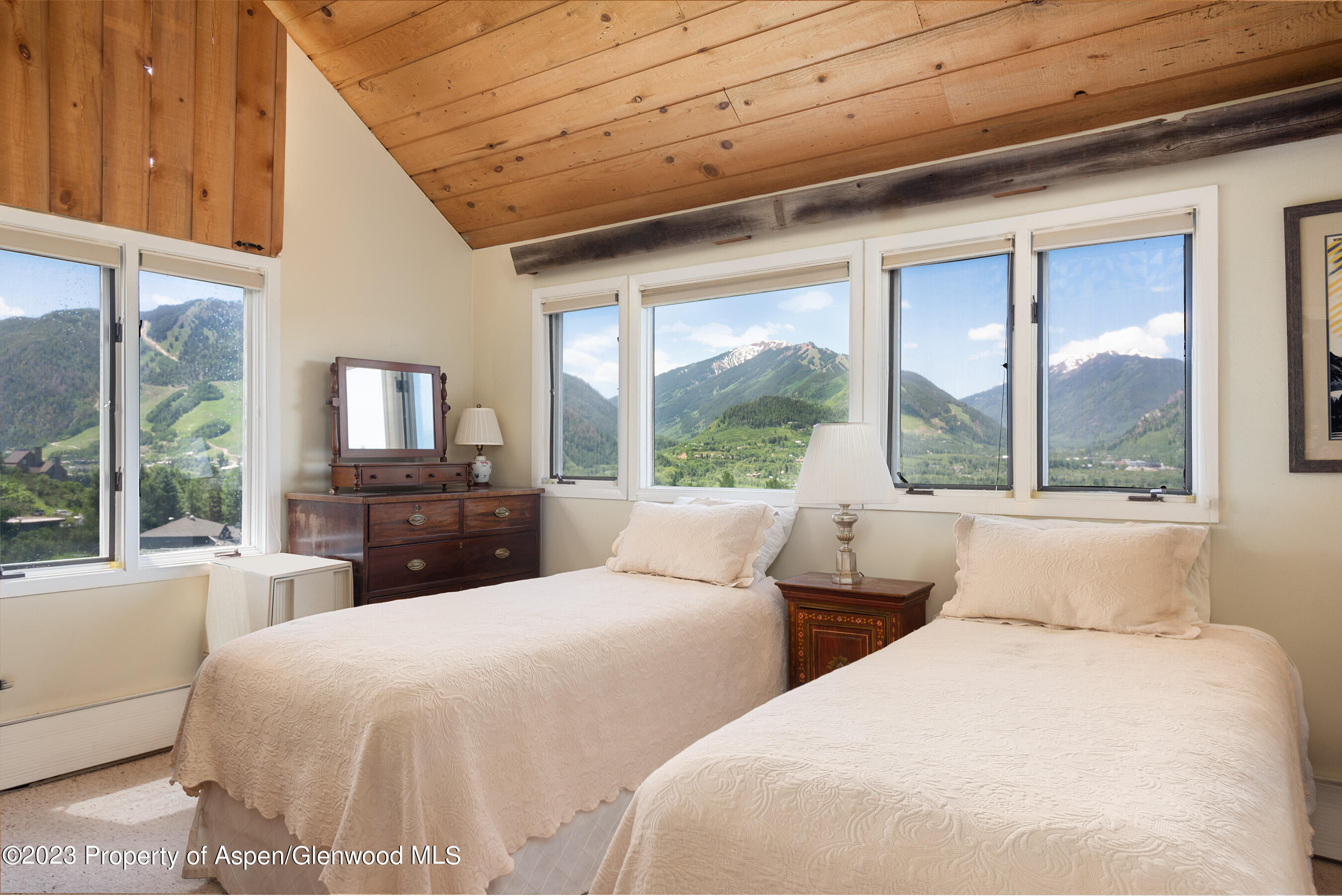 376 Draw Drive Aspen, CO 81612 - Photo 9 of 34 a bedroom with two large bed and a large window