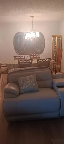 a living room with furniture and a chandelier