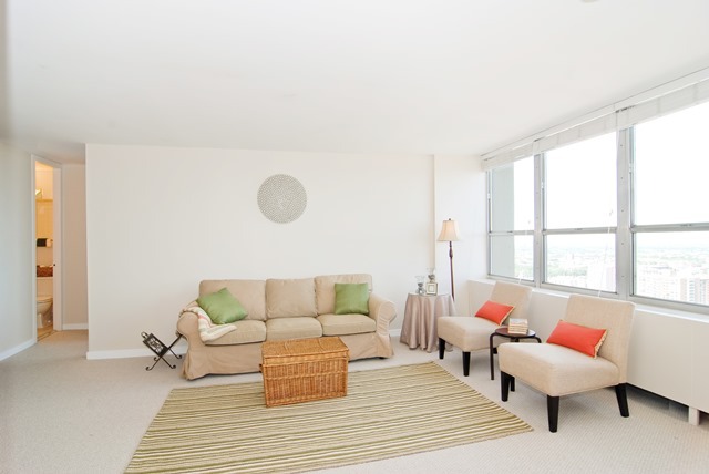 655 West Irving Park Road, Unit 3614 Chicago, IL 60613 - Photo 5 of 10 a living room with furniture and a large window
