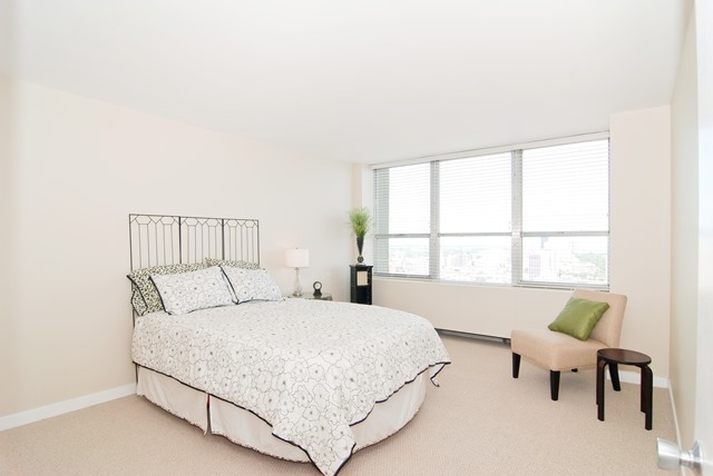 655 West Irving Park Road, Unit 3614 Chicago, IL 60613 - Photo 8 of 10 a bedroom with a bed and a window