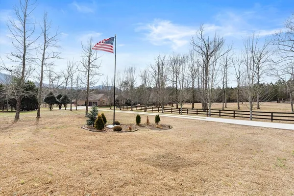 a kitchen with stainless steel appliances kitchen island granite countertop a stove refrigerator and cabinets
