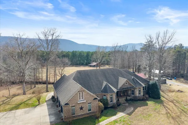 a aerial view of a house with a big yard and large trees