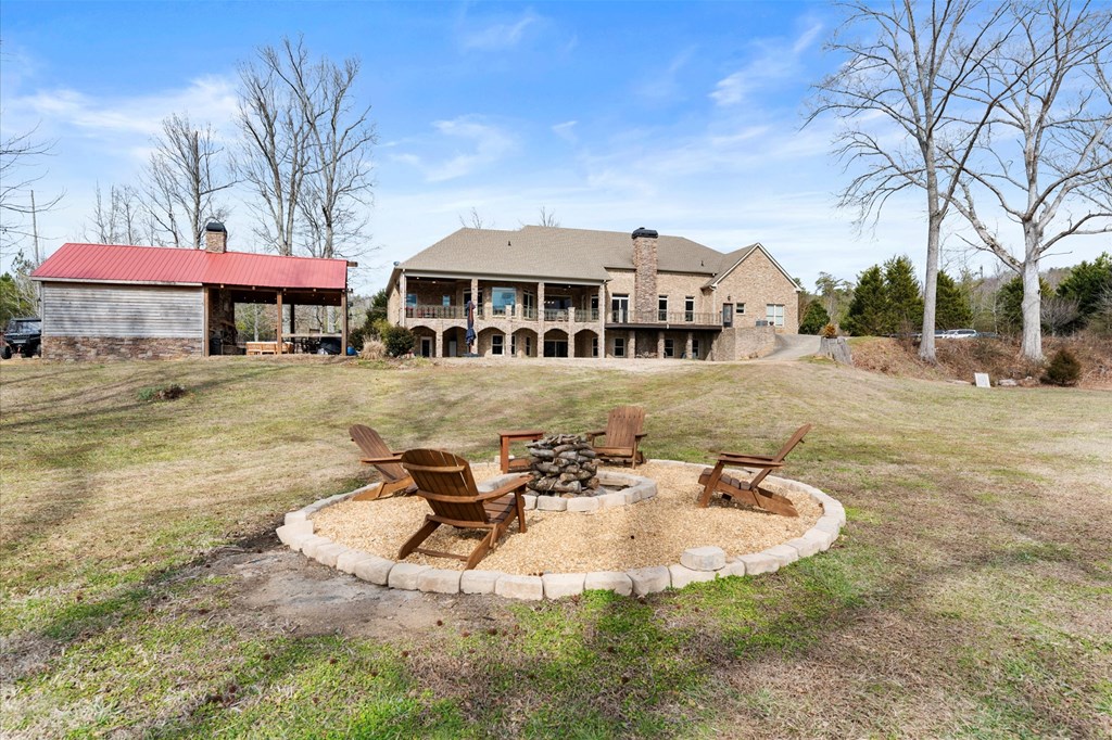 456 East Valley Road Northeast Rydal, GA 30171 - Photo 23 of 98 a view of a white house with a yard porch and sitting area