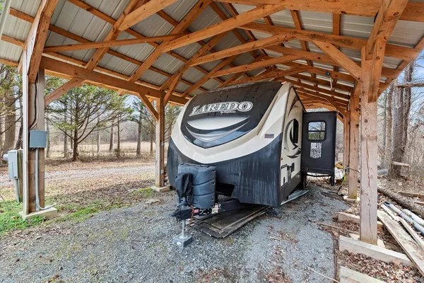 a view of living room and kitchen with furniture and large window