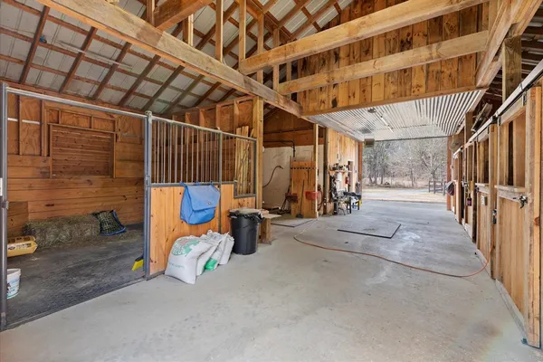 a living room with a large window and a rug