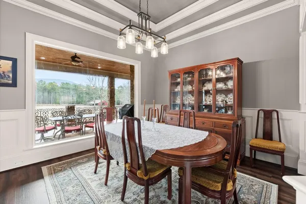 a living room with furniture a large window and a flat screen tv