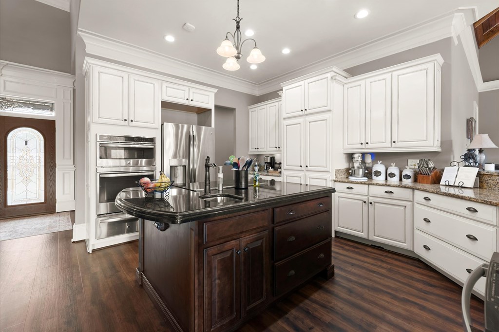 456 East Valley Road Northeast Rydal, GA 30171 - Photo 40 of 98 a kitchen with stainless steel appliances kitchen island granite countertop a stove refrigerator and cabinets