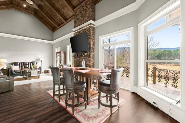 a bedroom with a bed a table and a large window