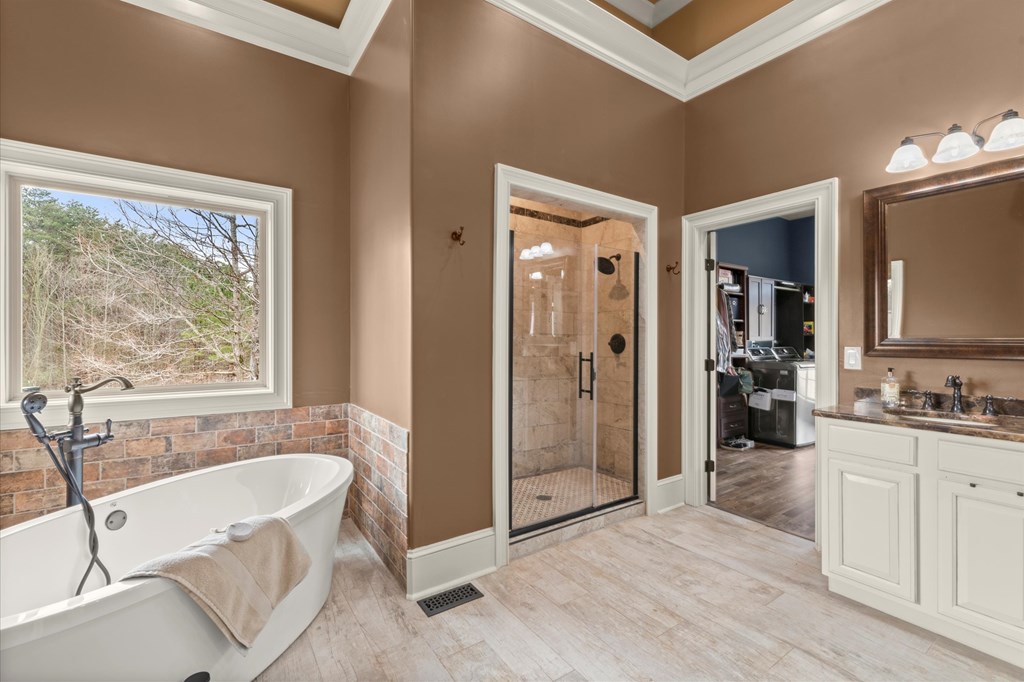456 East Valley Road Northeast Rydal, GA 30171 - Photo 65 of 98 a spacious bathroom with a tub a double vanity sink a mirror and a shower