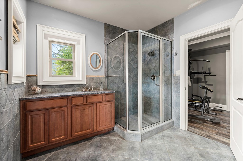 456 East Valley Road Northeast Rydal, GA 30171 - Photo 71 of 98 a bathroom with a shower a sink and a mirror