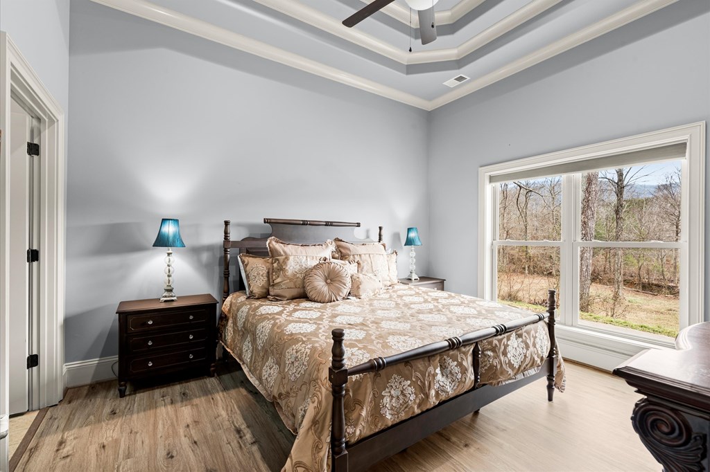 456 East Valley Road Northeast Rydal, GA 30171 - Photo 88 of 98 a bedroom with a bed a table and a large window