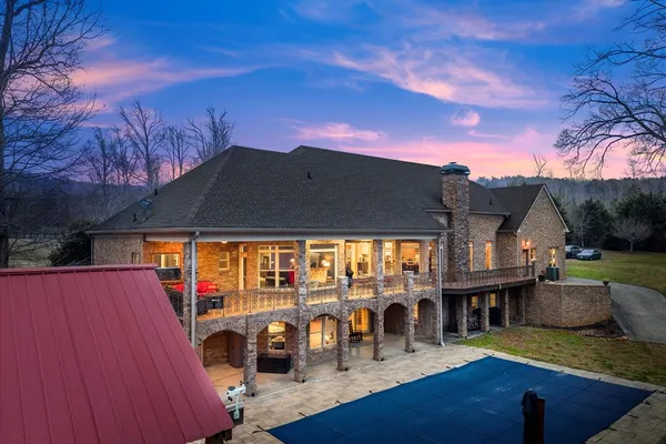 a view of a white house with a yard porch and sitting area