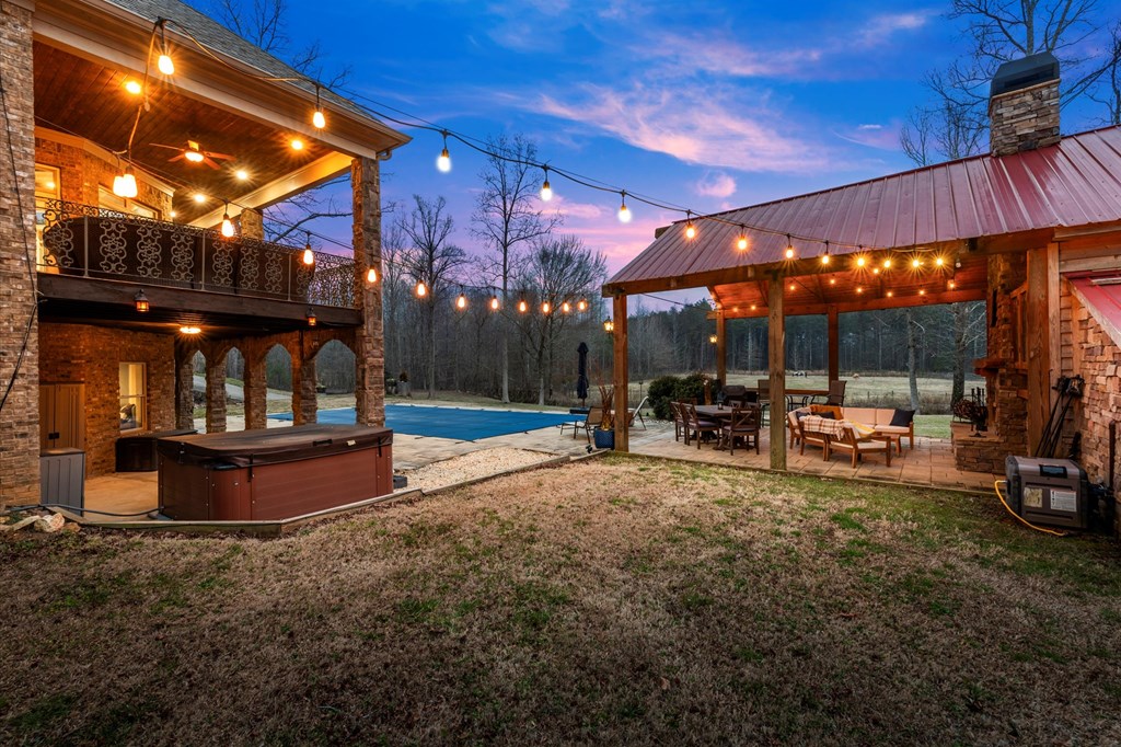 456 East Valley Road Northeast Rydal, GA 30171 - Photo 93 of 98 a view of a big yard with table and chairs under an umbrella