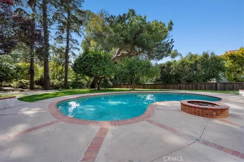 a view of a swimming pool with a yard