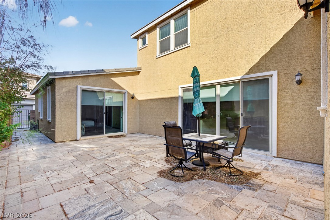 1100 East Sunset Road Henderson, NV 89011 - Photo 50 of 58 A spacious, stone-tiled patio offers ample room for outdoor gatherings and relaxation.