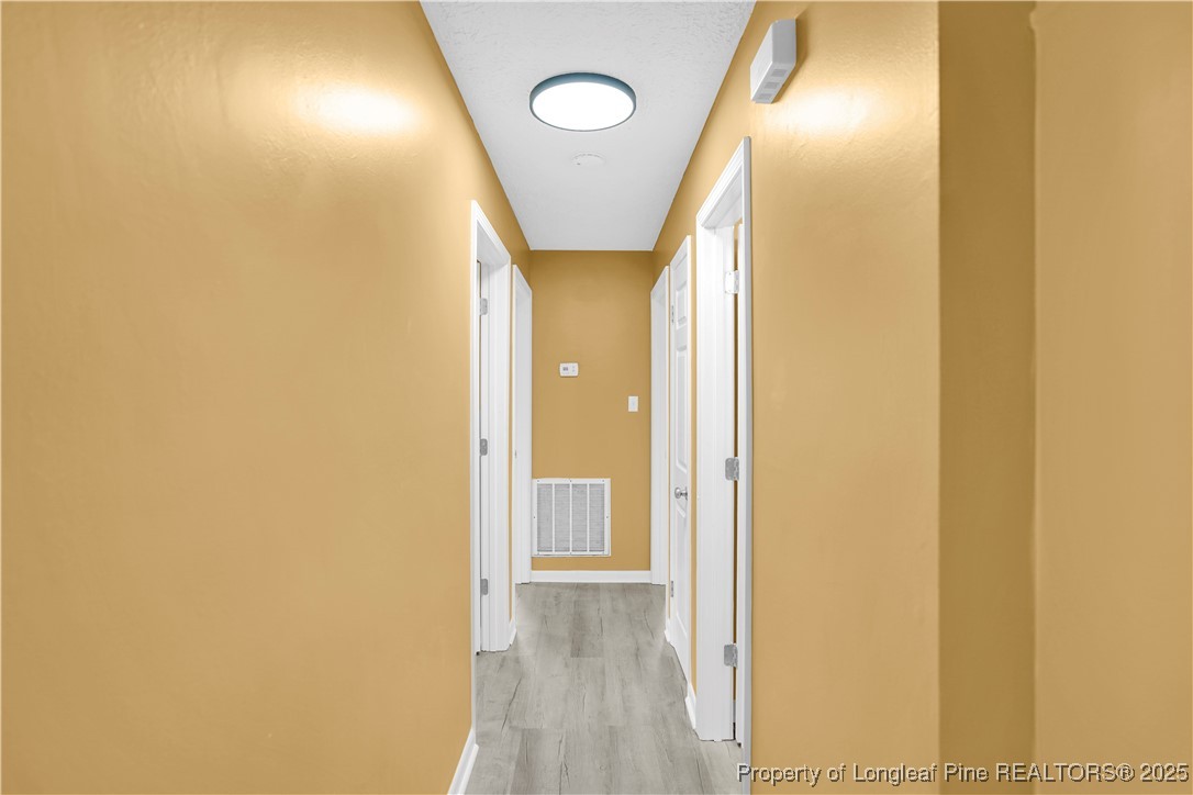 2218 Chason Road Lumber Bridge, NC 28357 - Photo 12 of 22 a view of a hallway with wooden floor