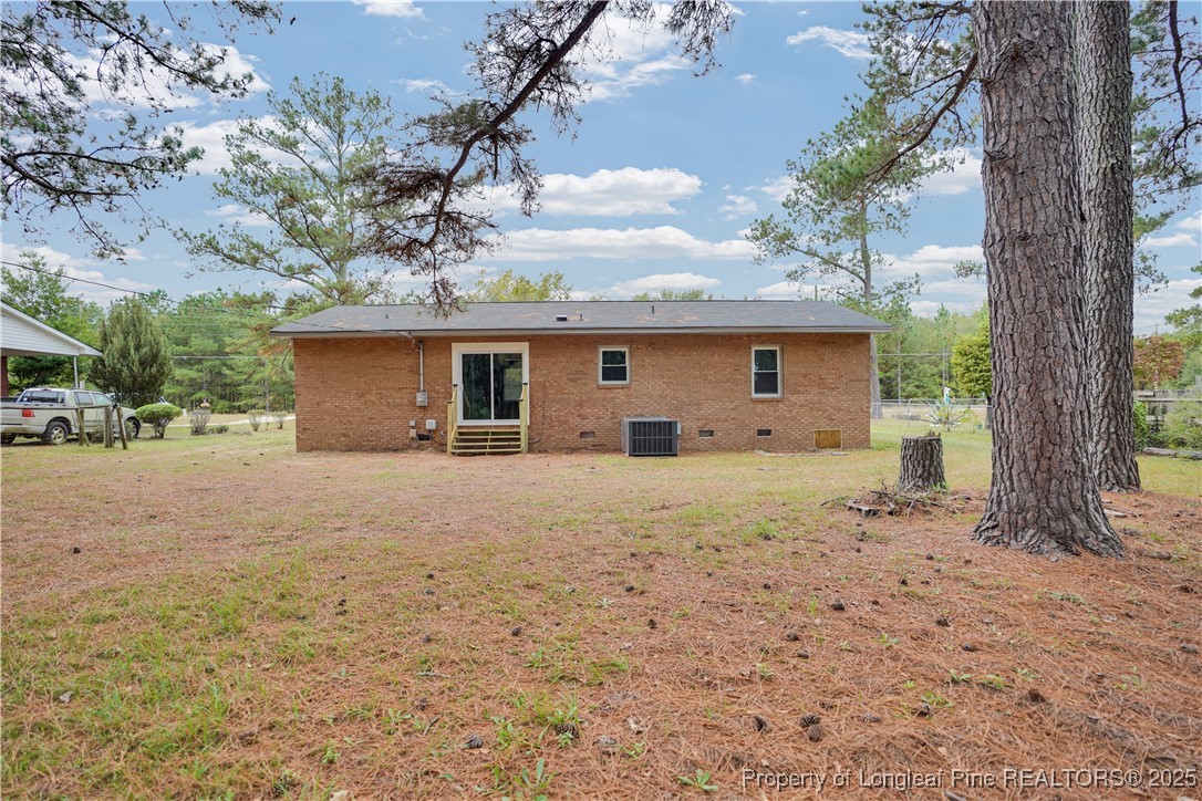 2218 Chason Road Lumber Bridge, NC 28357 - Photo 21 of 22 a view of a house with backyard and trees