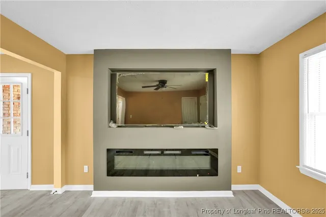 a living room with a fireplace and a window