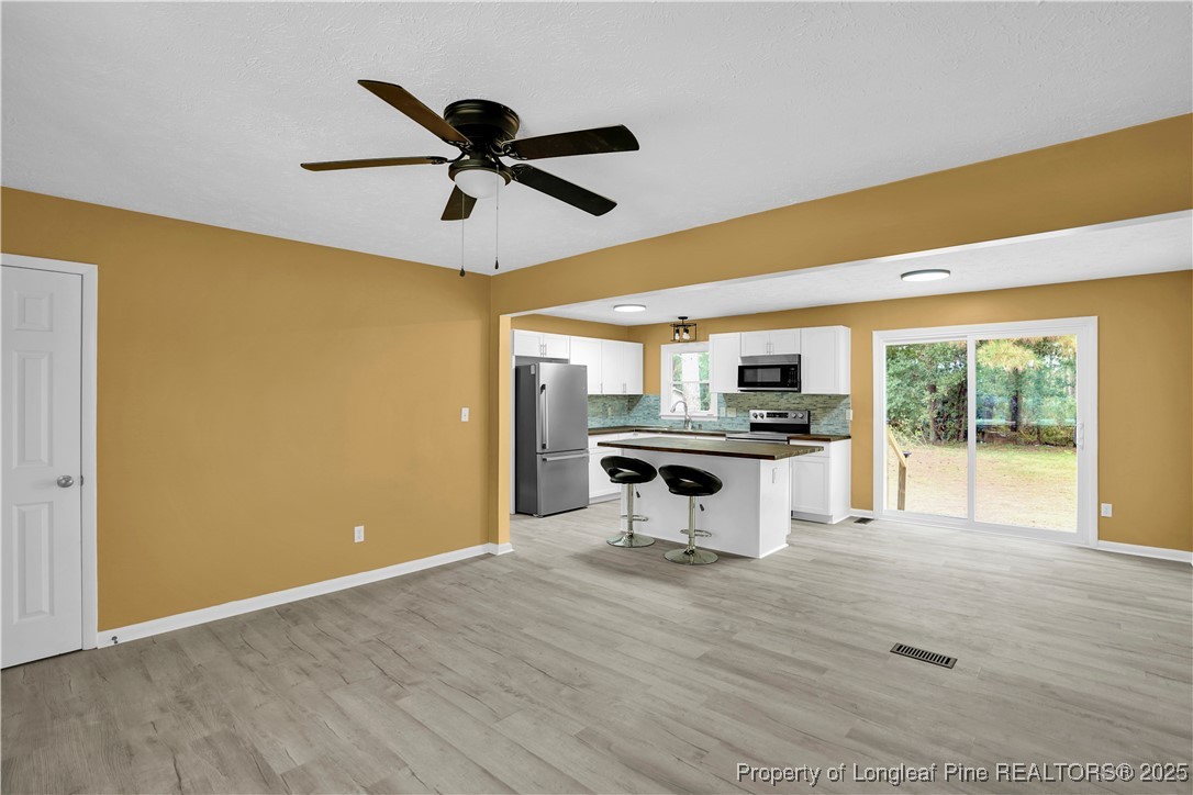 2218 Chason Road Lumber Bridge, NC 28357 - Photo 5 of 22 a kitchen with stainless steel appliances kitchen island a refrigerator and a stove