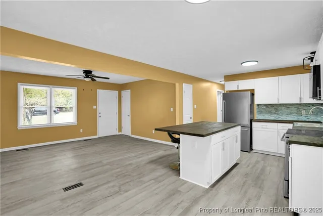 a kitchen with stainless steel appliances granite countertop a stove and a refrigerator