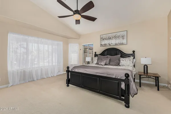 a bedroom with a bed and a chandelier