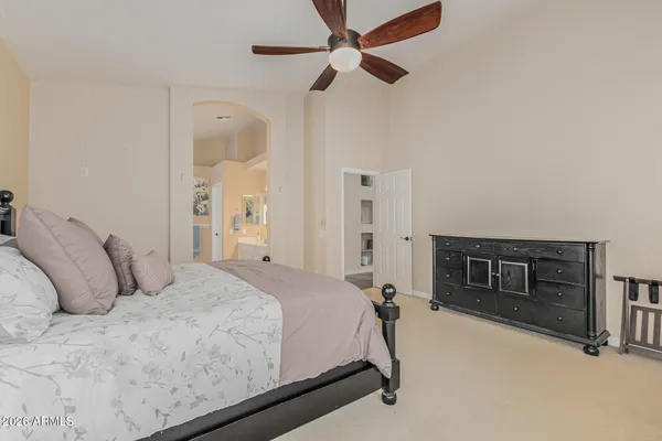 a bedroom with a bed and ceiling fan