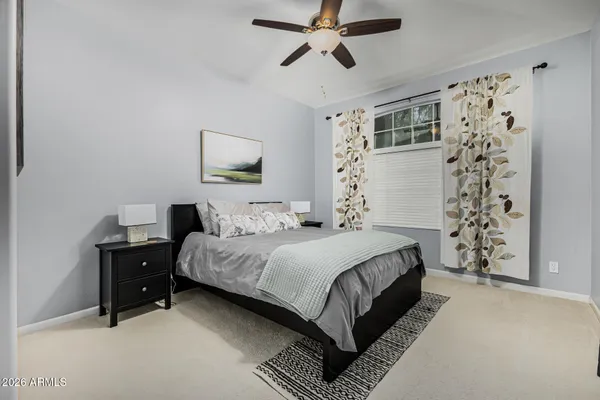 a bedroom with a bed and a window