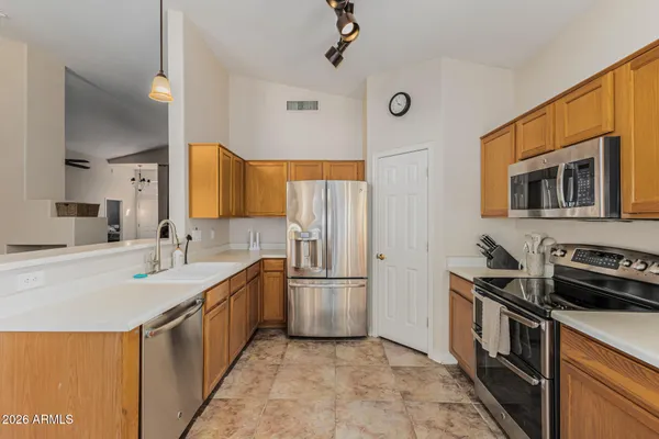a kitchen with stainless steel appliances granite countertop a sink stove and refrigerator