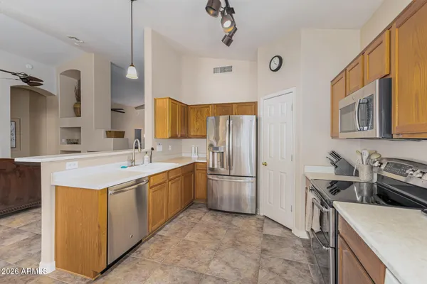 a kitchen with a sink stove and refrigerator