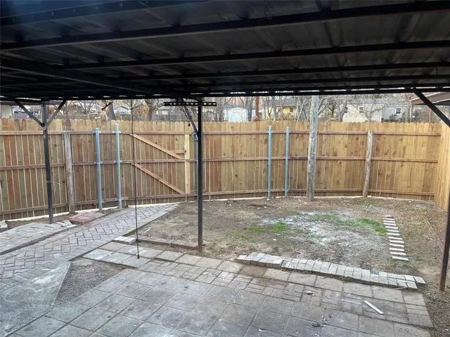 a backyard of a house with a wooden fence