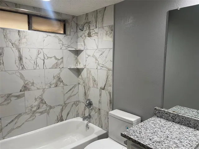 a bathroom with a bathtub and shower