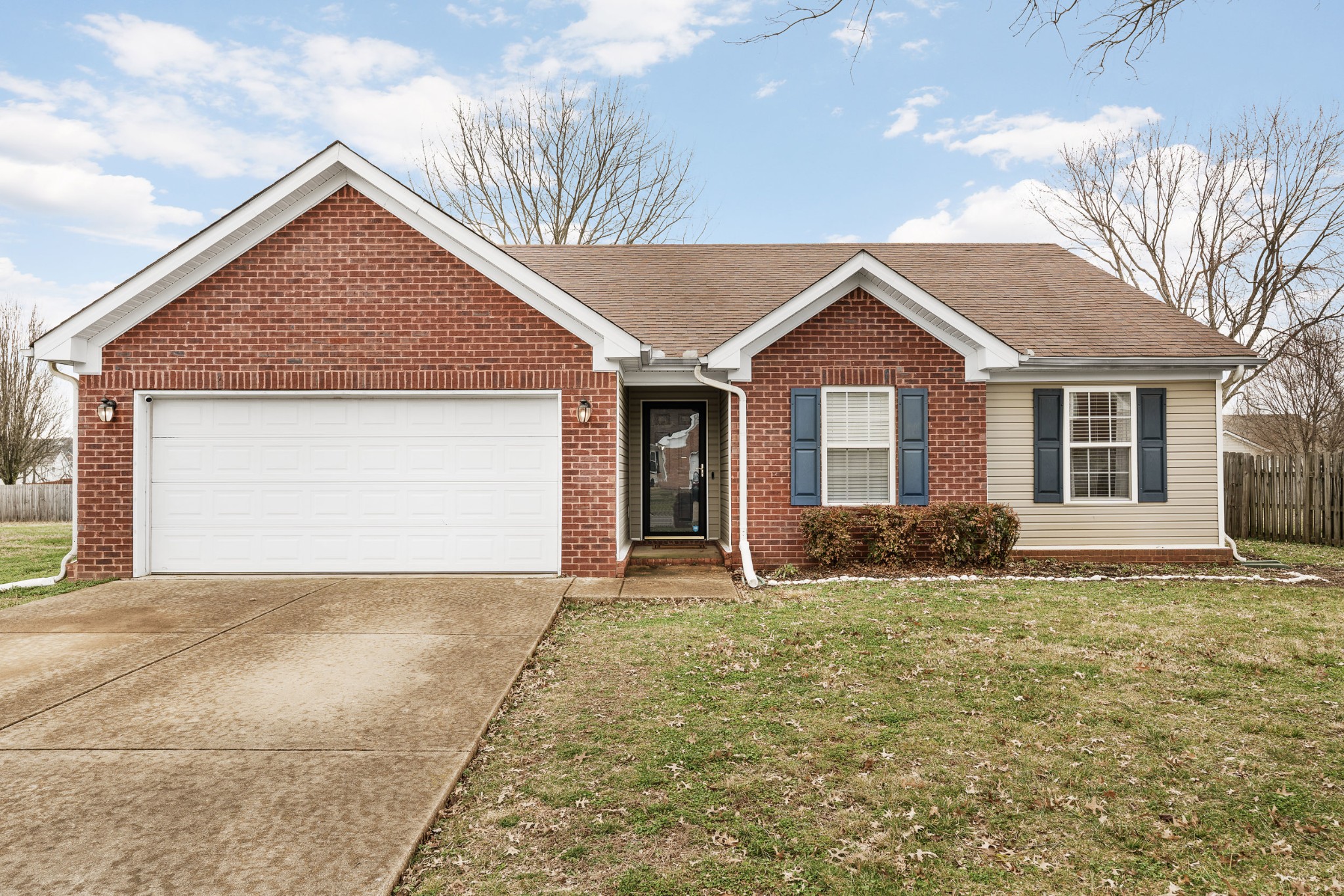 2213 New Port Drive Spring Hill, TN 37174 - Photo 1 of 32 a front view of a house with a yard and garage