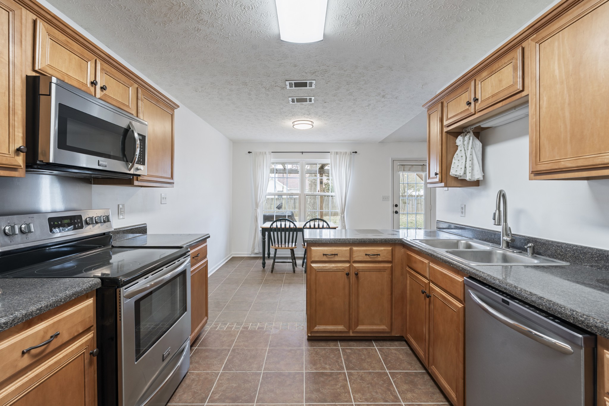 2213 New Port Drive Spring Hill, TN 37174 - Photo 11 of 32 a kitchen with a sink stove top oven and microwave